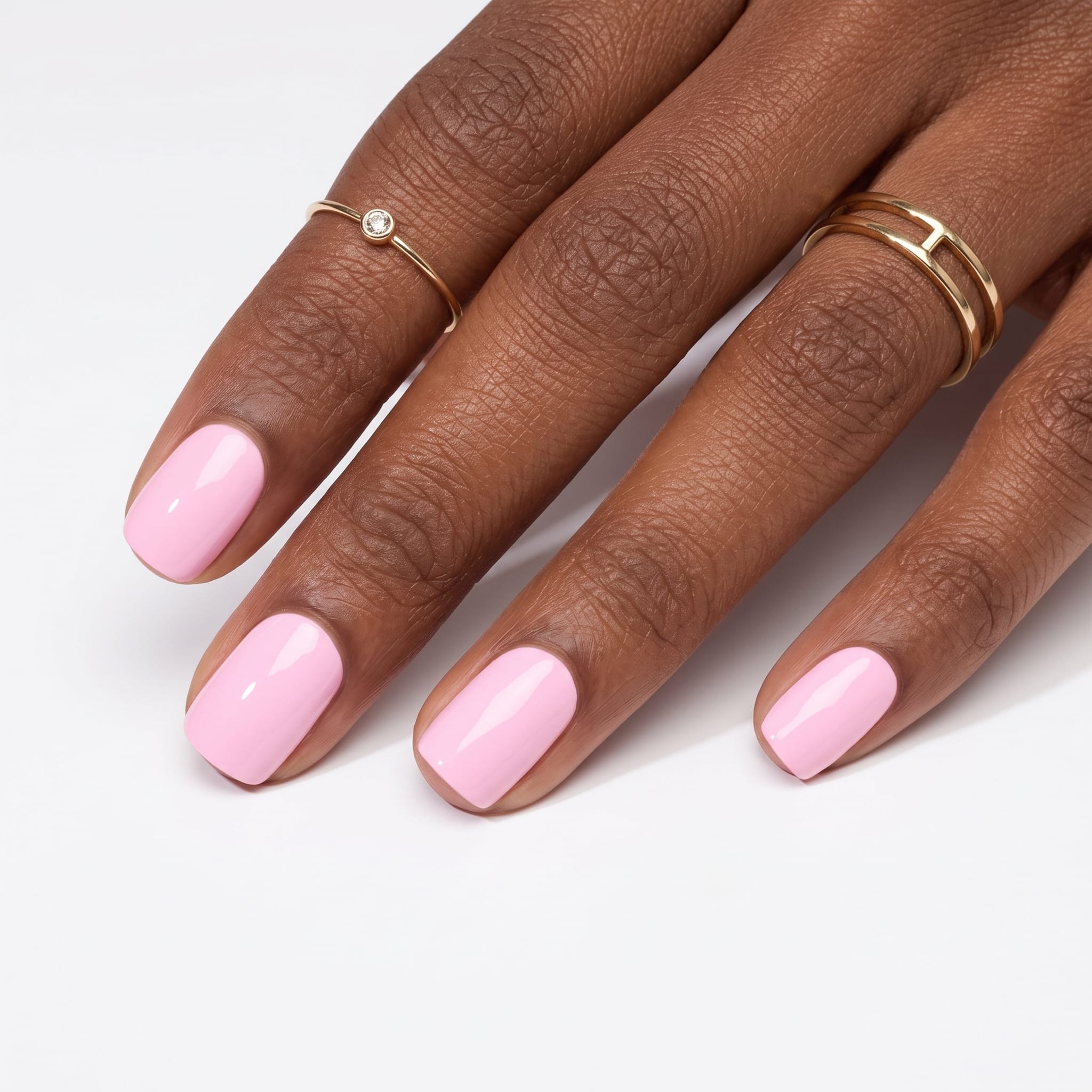 Vibrant hot pink glossy nails on a neutral hand pose