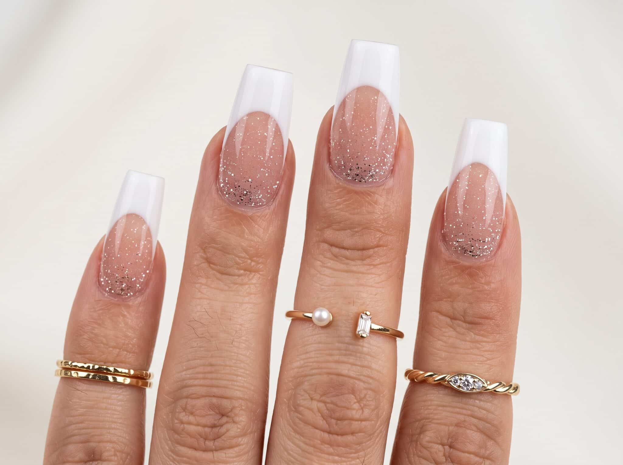 Clean pink and white full set nails on both hands with a soft glossy finish