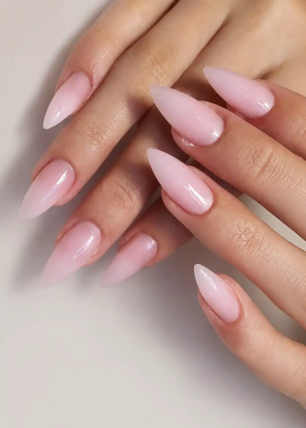 Glossy milky pink almond shaped nails