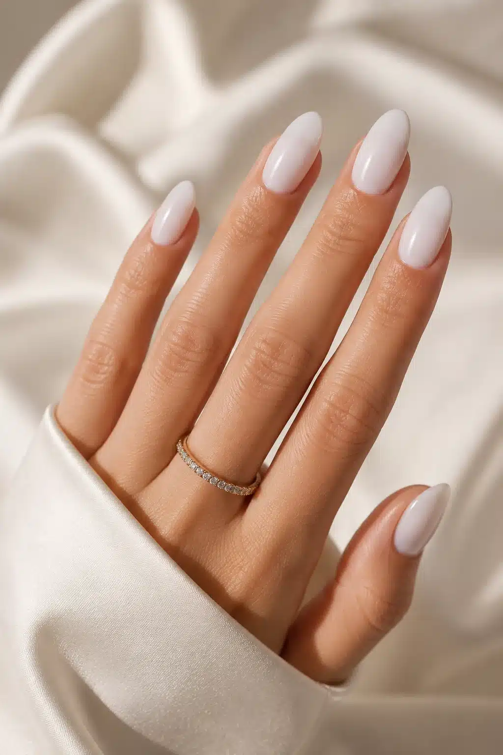 Milky White Nail Designs: Soft Chrome, French, Glitter & Almond Ideas 4 Clean almond milky white nail designs on a neutral satin background