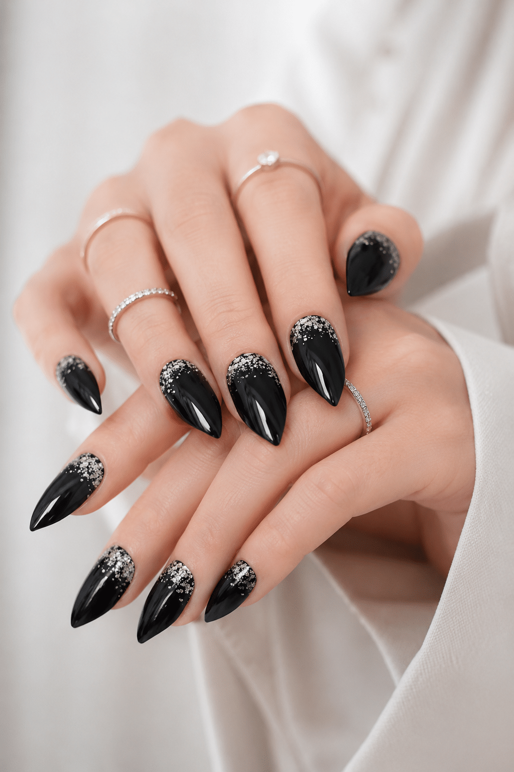 black gel stiletto nails with glossy dark dramatic finish