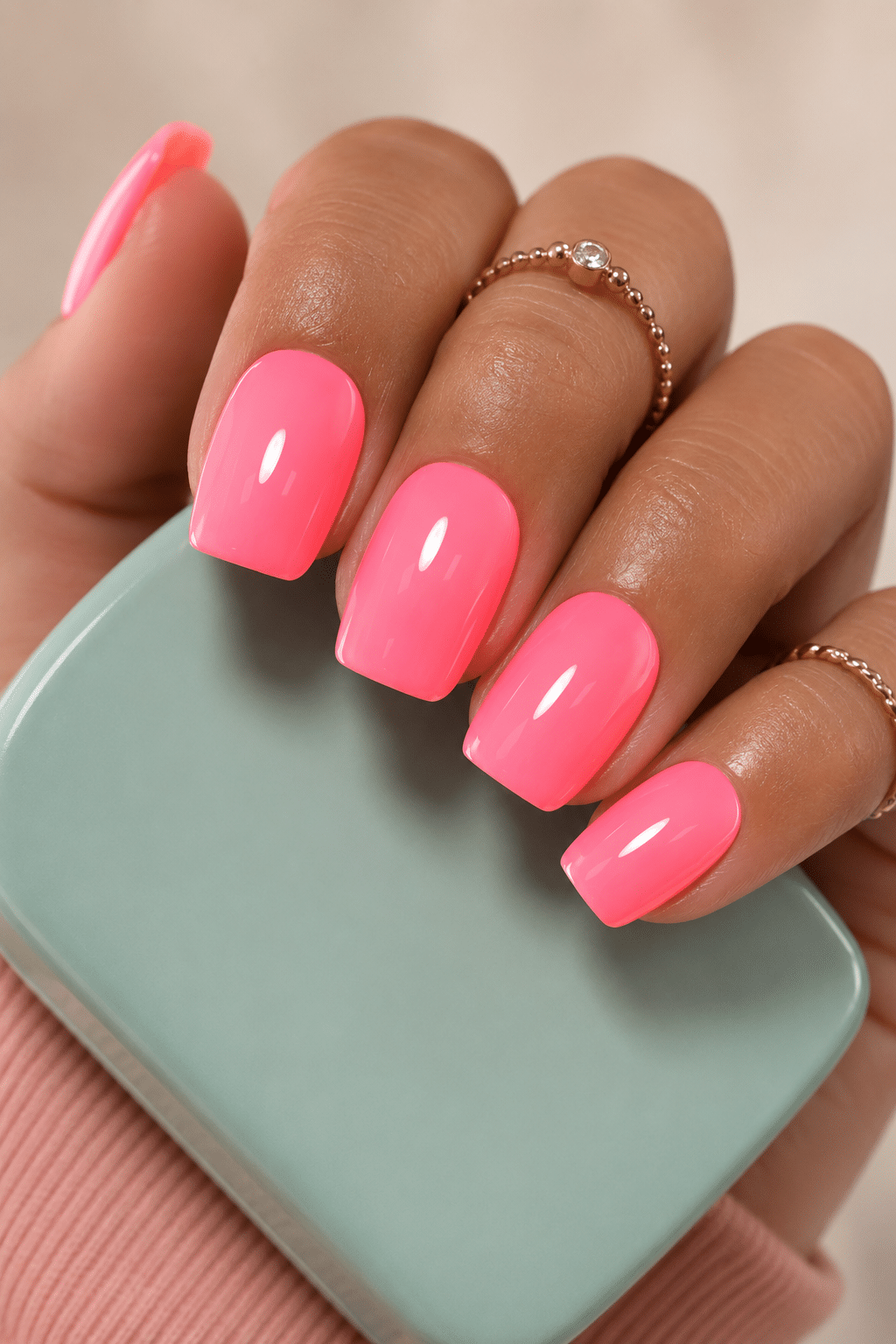 Bright neon pink square nails with a smooth glossy varnish finish