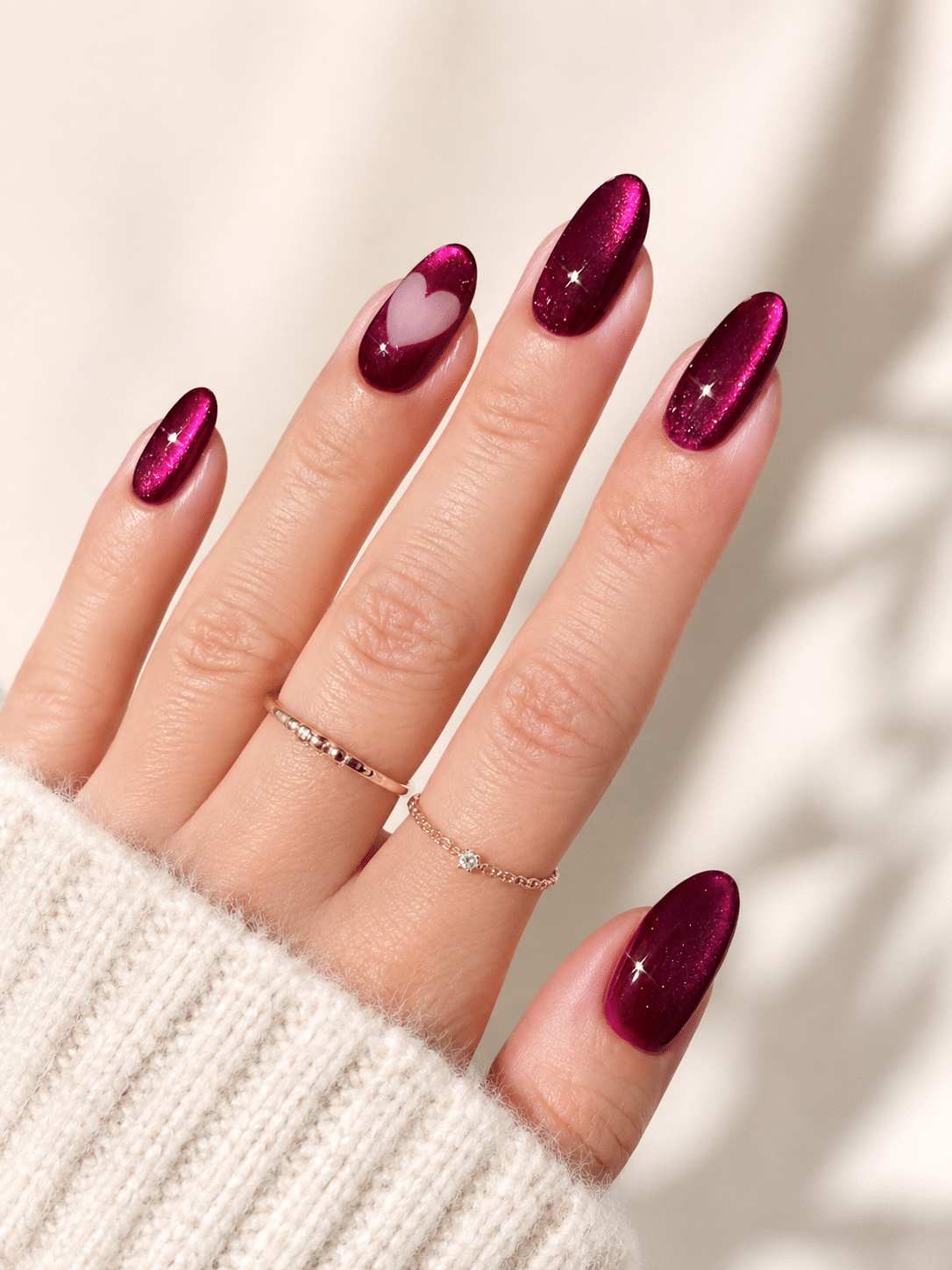 Deep magenta cat eye nails with a dark glossy magnetic finish