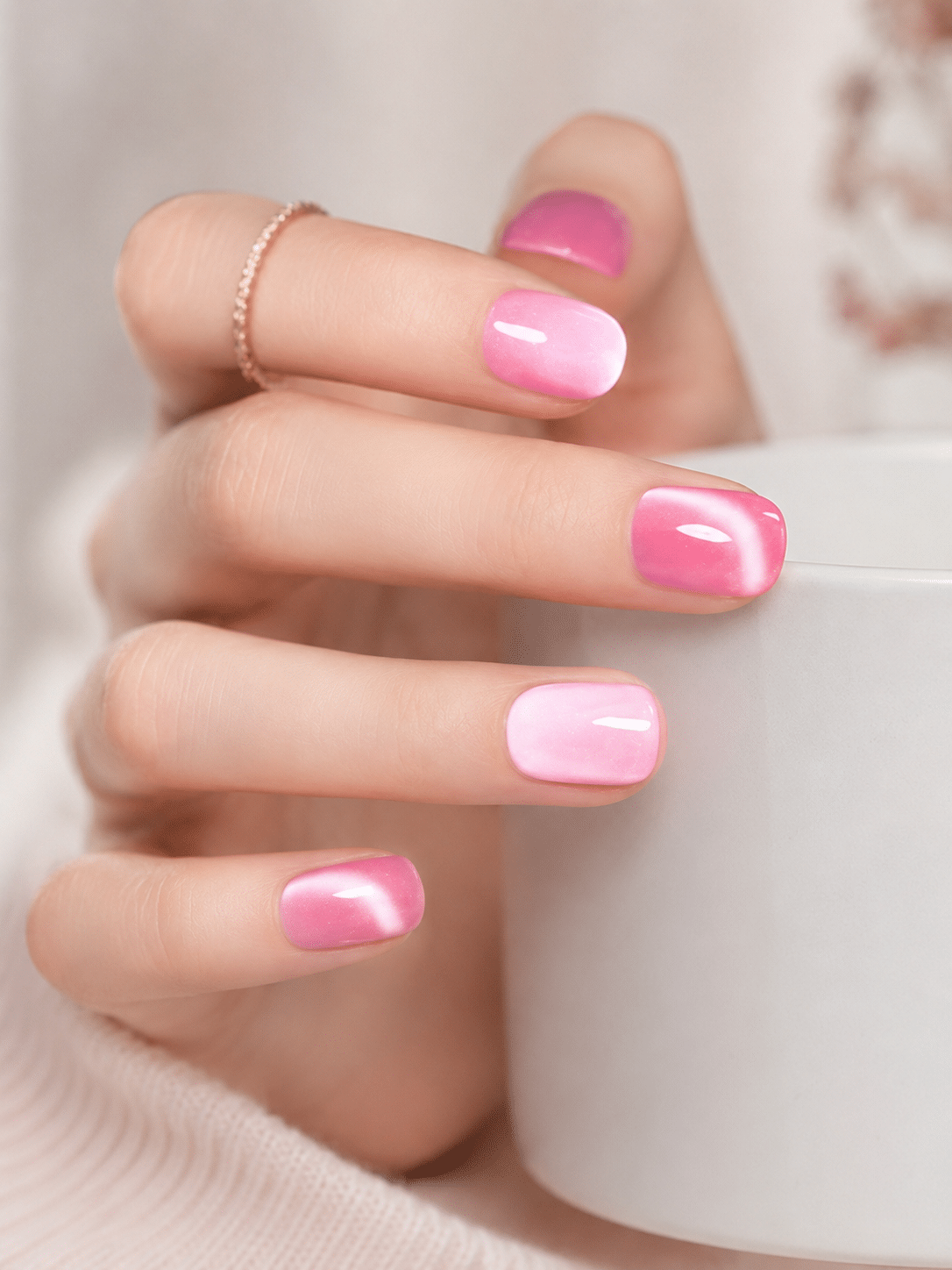 Glossy candy pink cat eye nails with a bright magnetic shine
