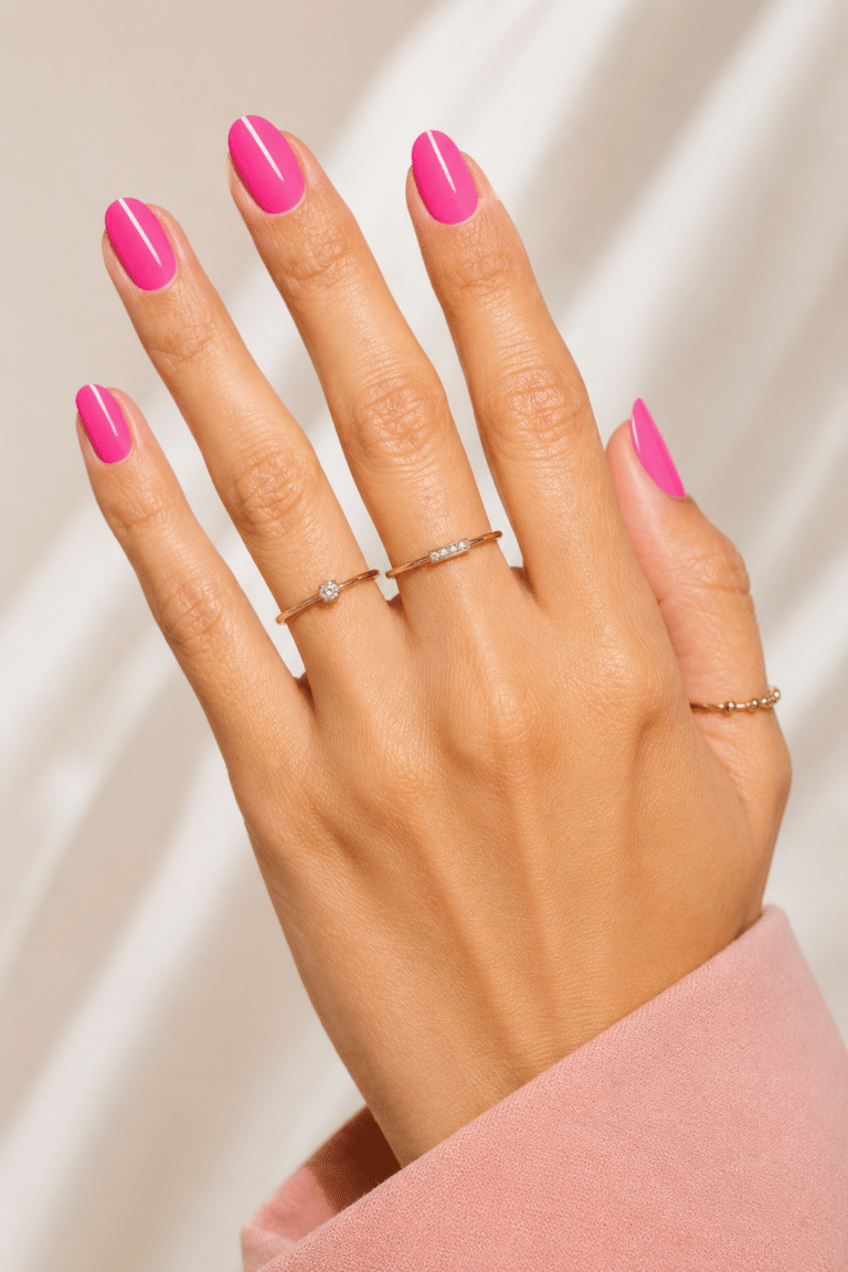 Glossy hot pink neon nails with a bright summer manicure finish
