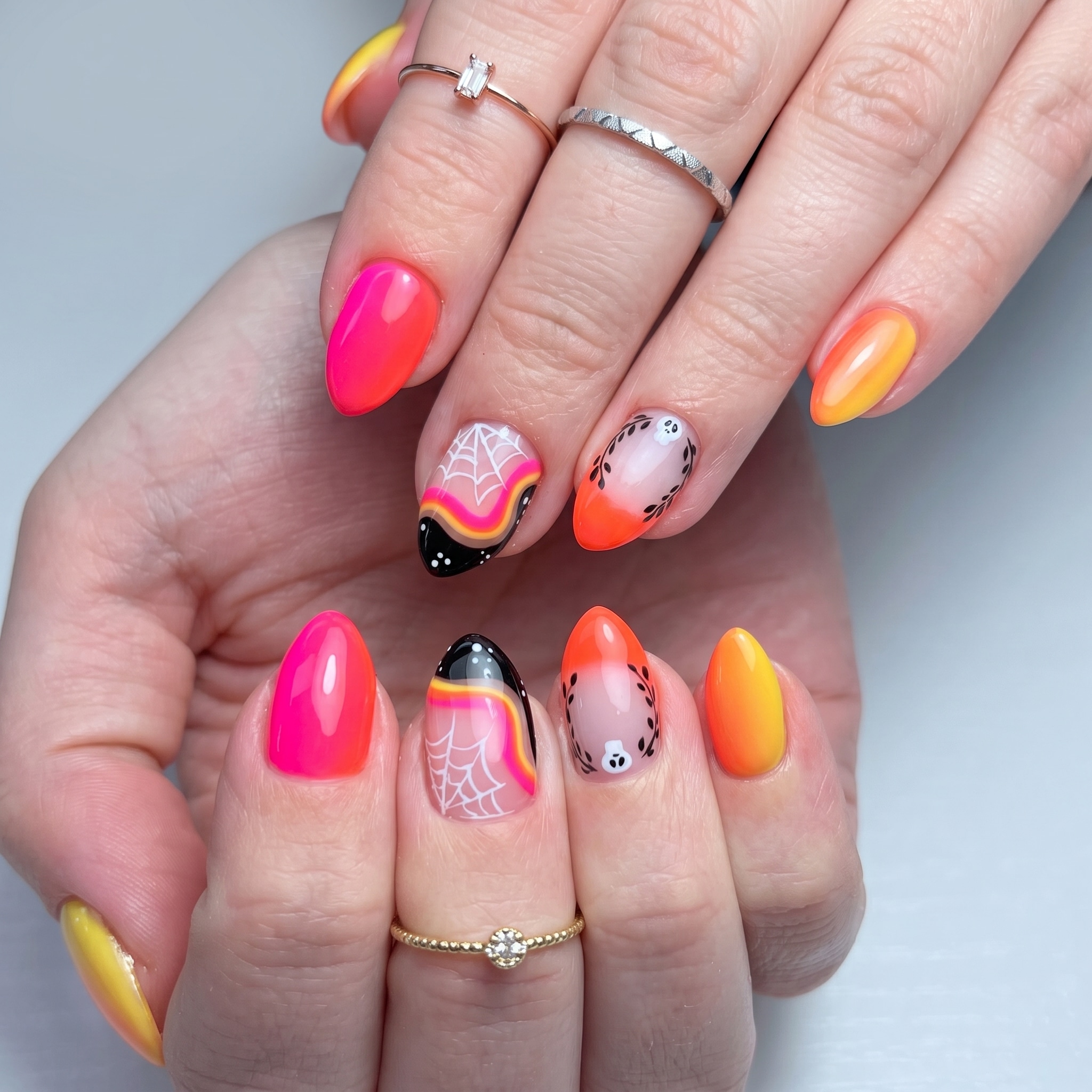 neon orange pink spooky nails with bright summer Halloween accents