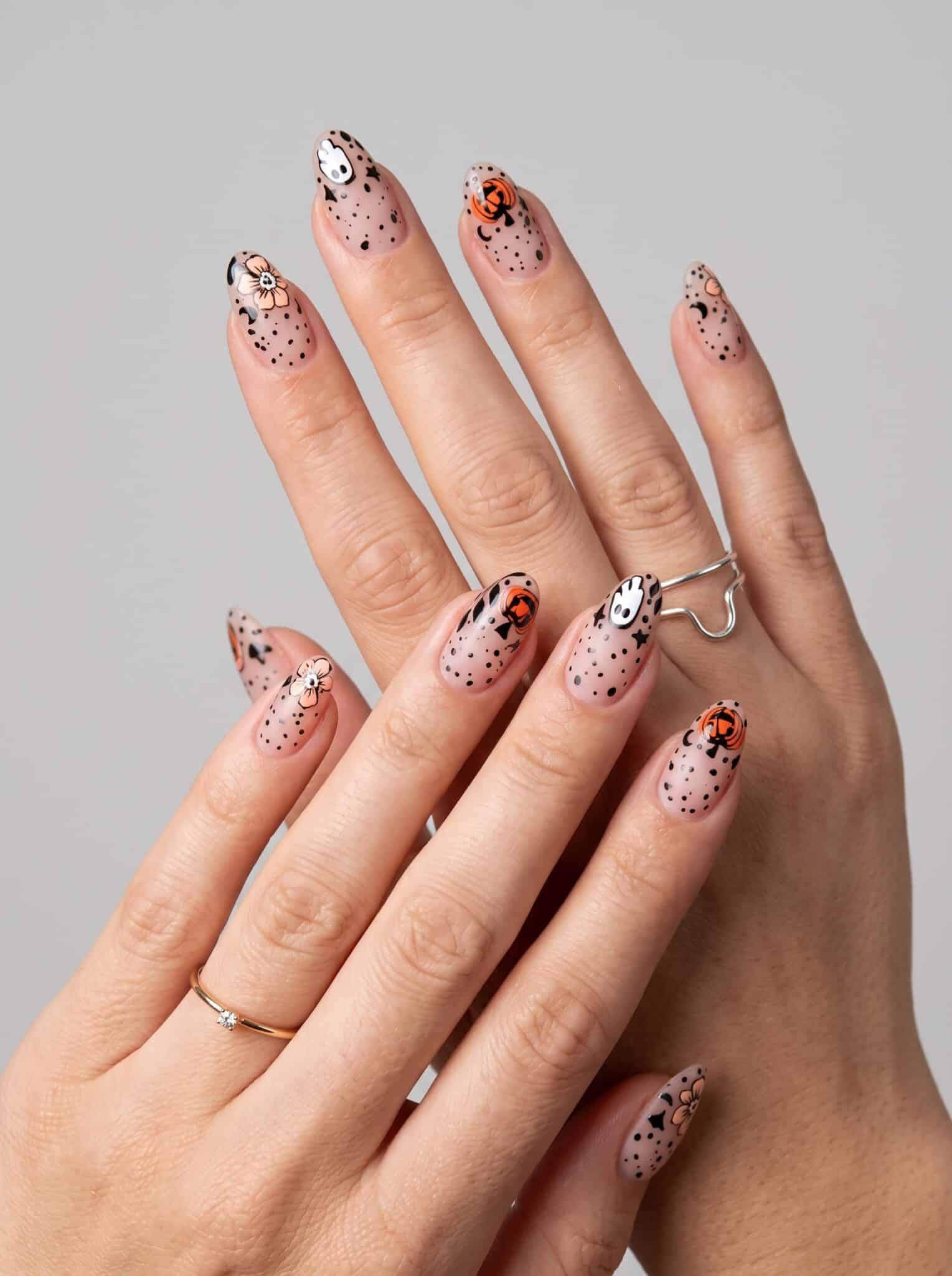 nude spooky summer manicure with tiny Halloween-inspired accents