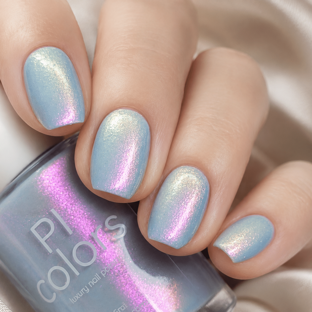 Pearl blue and pink chrome nails with a reflective shimmer finish