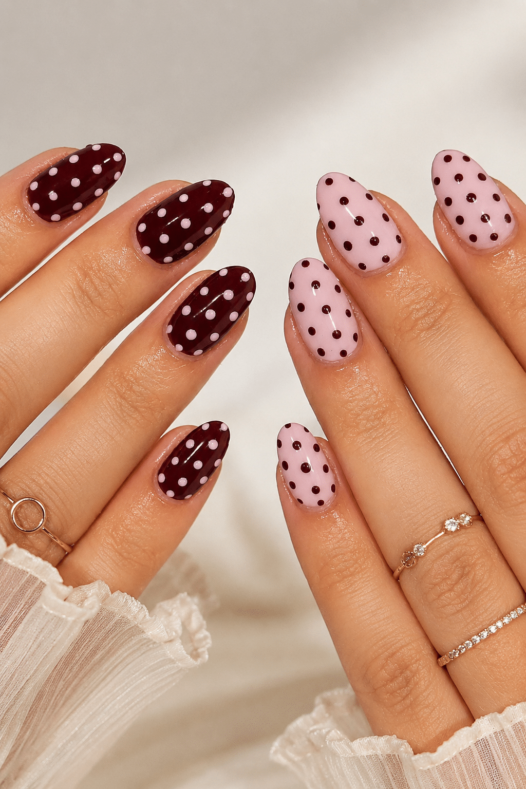 Pink gel nail art with dot accents and a glossy manicure finish