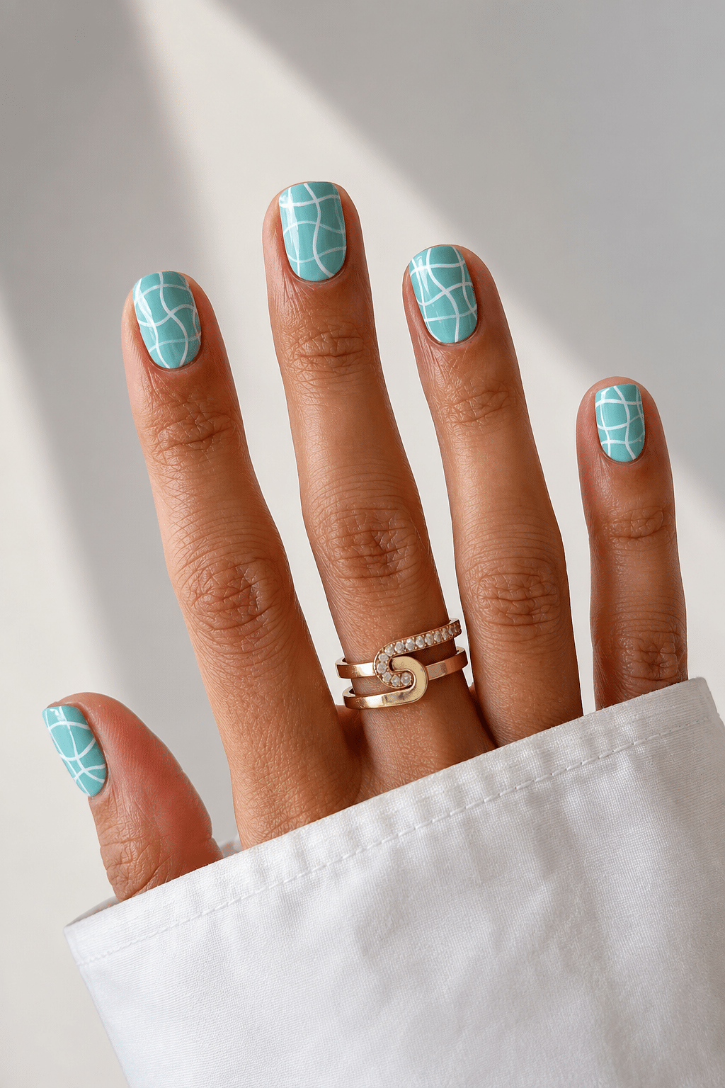 Sea glass blue summer nail design 2026 with glossy coastal manicure finish