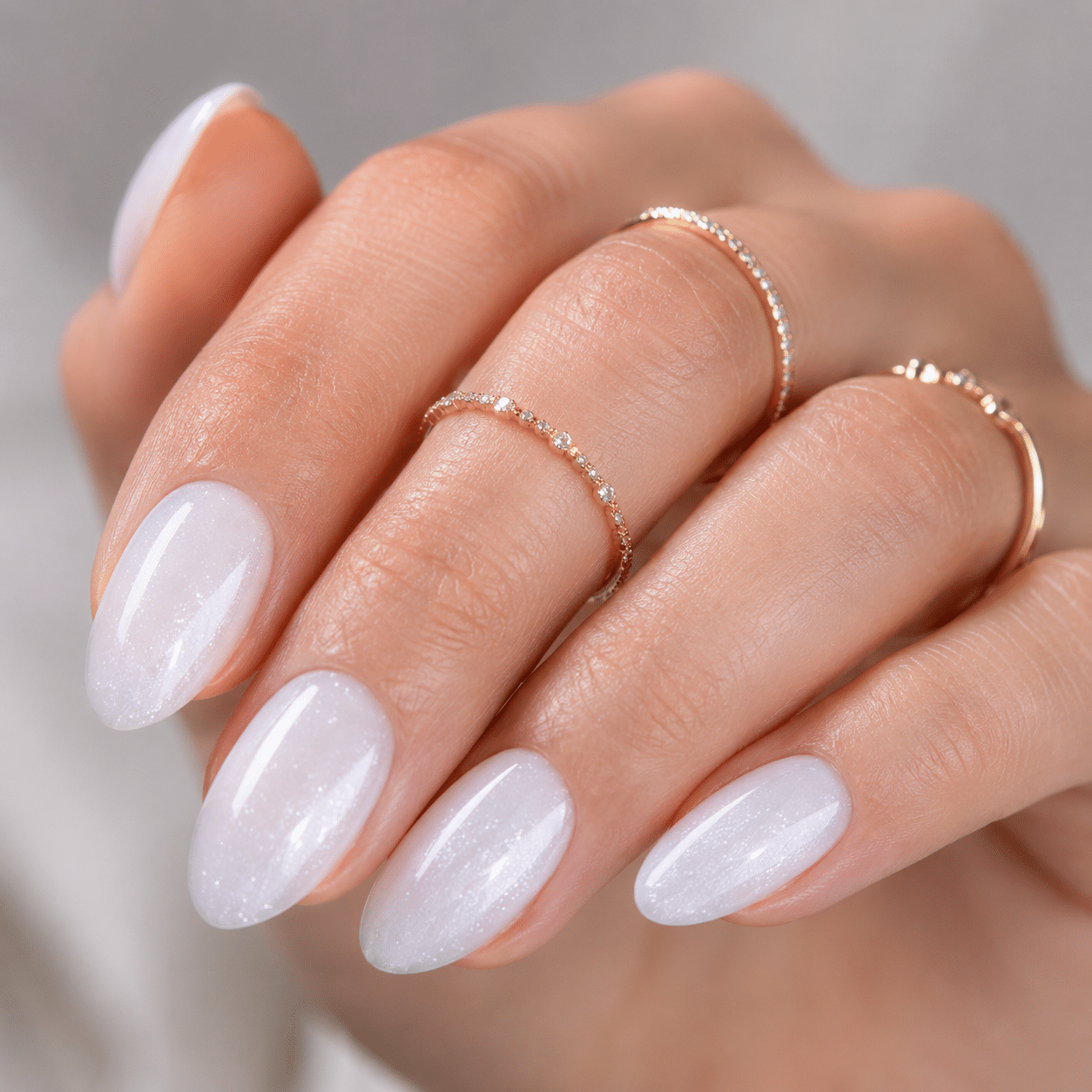Sheer pearl white gel nail polish with glossy translucent manicure finish