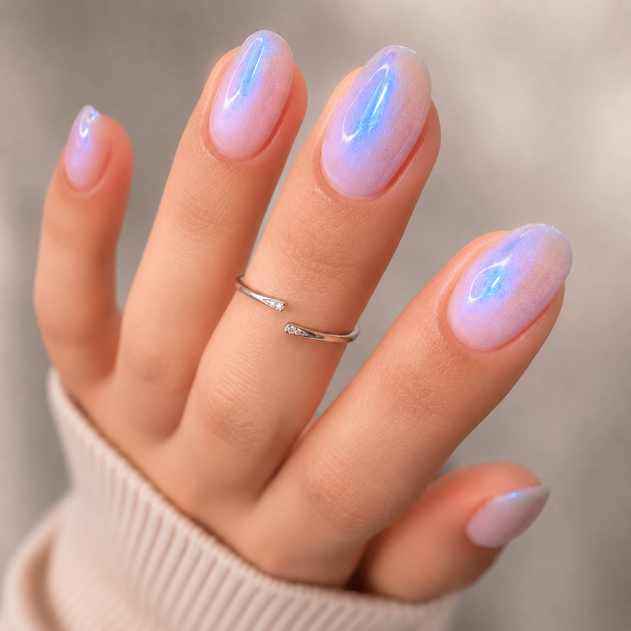 Soft almond pink and blue glow nails with a glossy shimmer finish