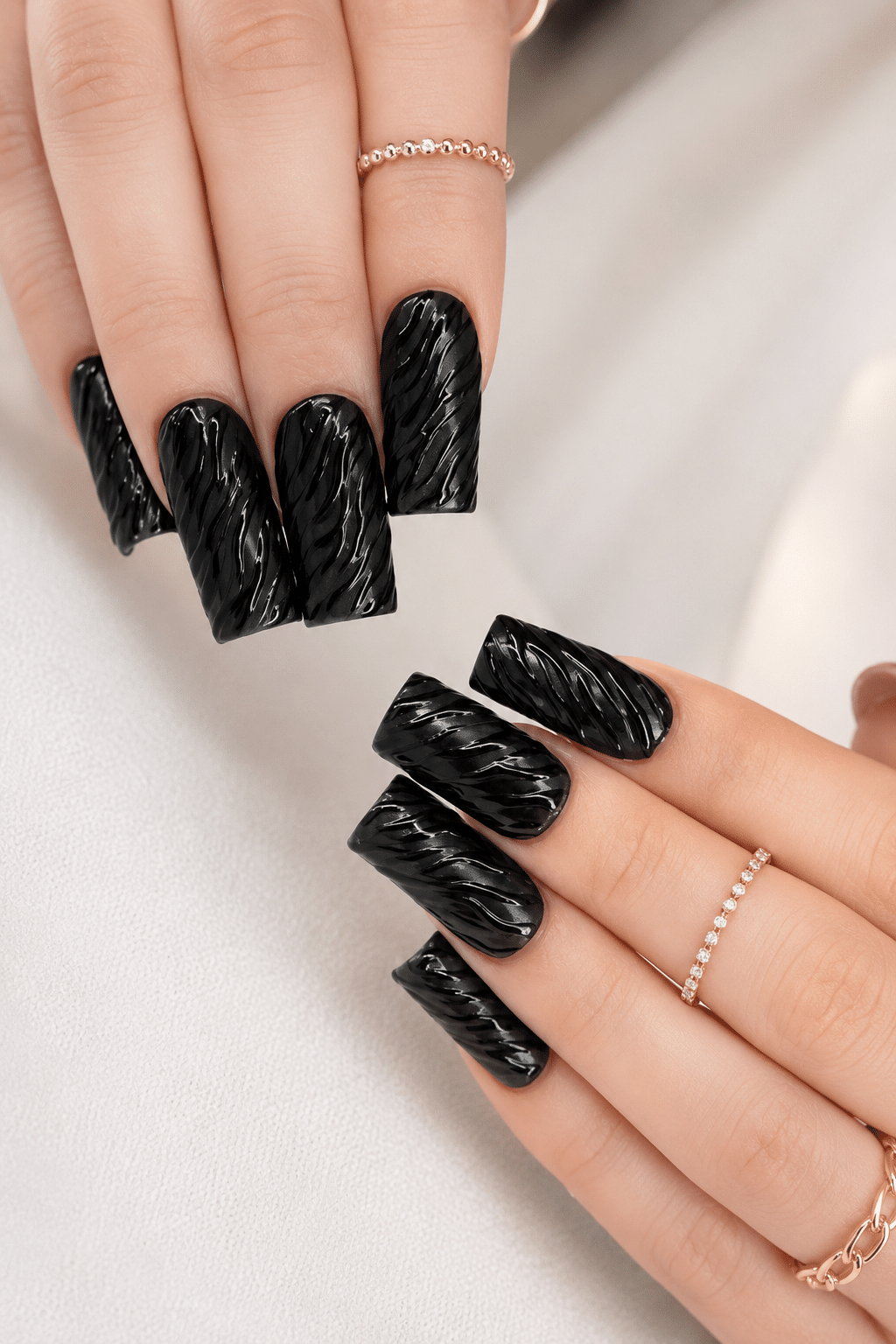 textured black gel nails with glossy dark nail art finish