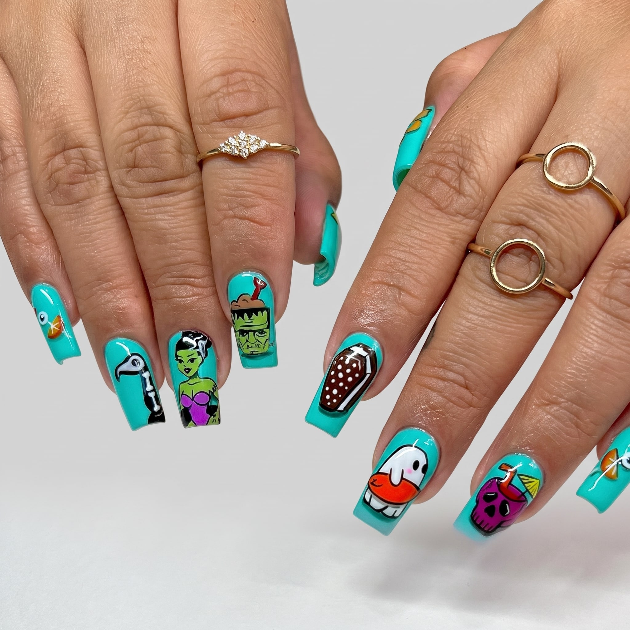 turquoise square nails with spooky summer characters and bright accents
