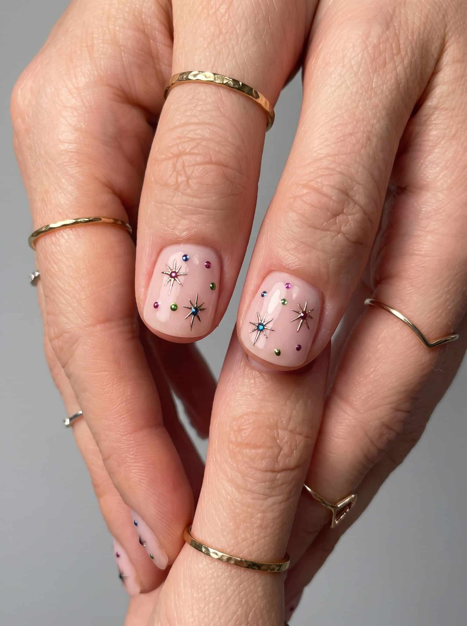 Nude manicure with tiny red dot accents