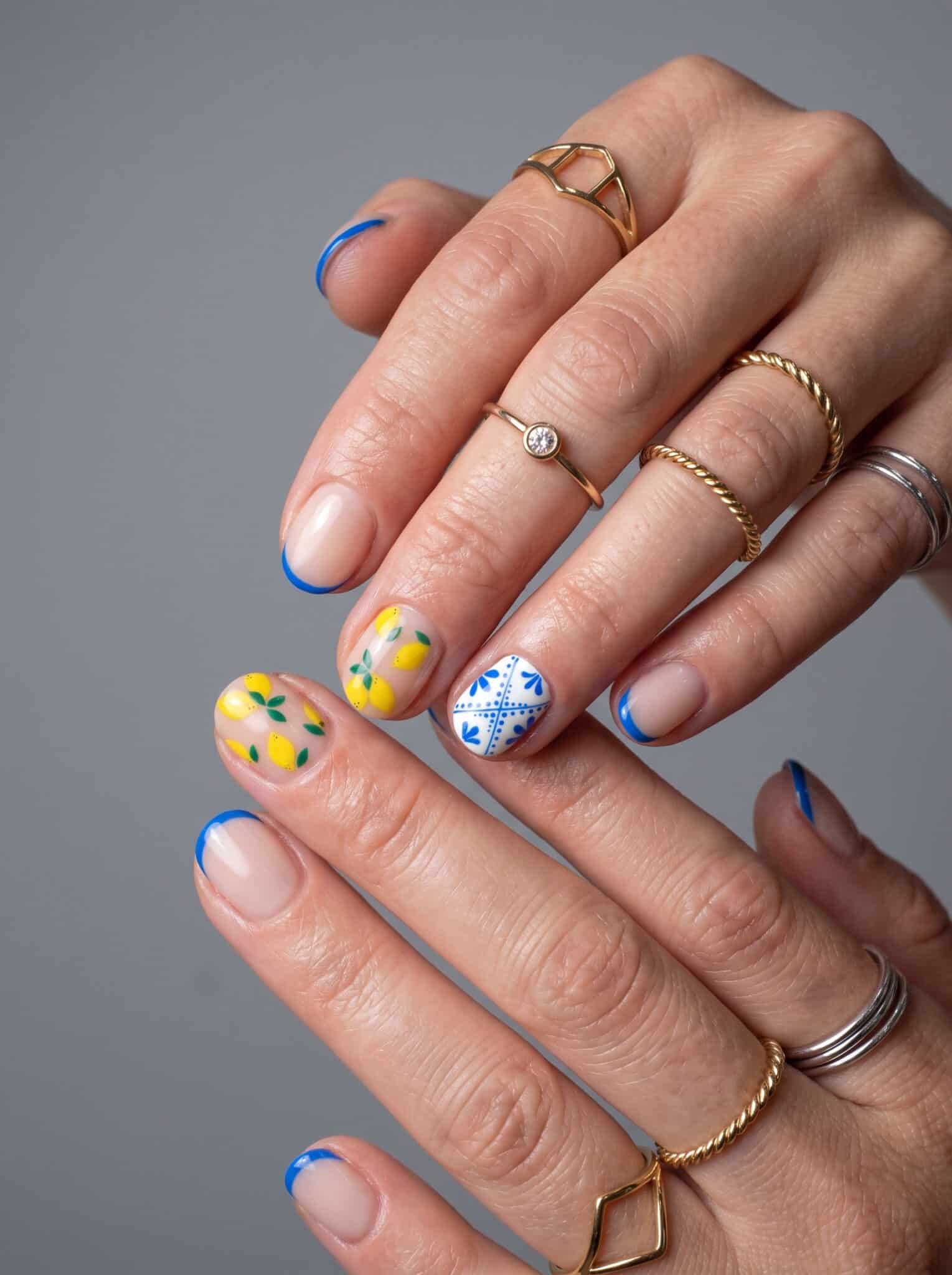 Nude manicure with small multicolor flower and dot accents