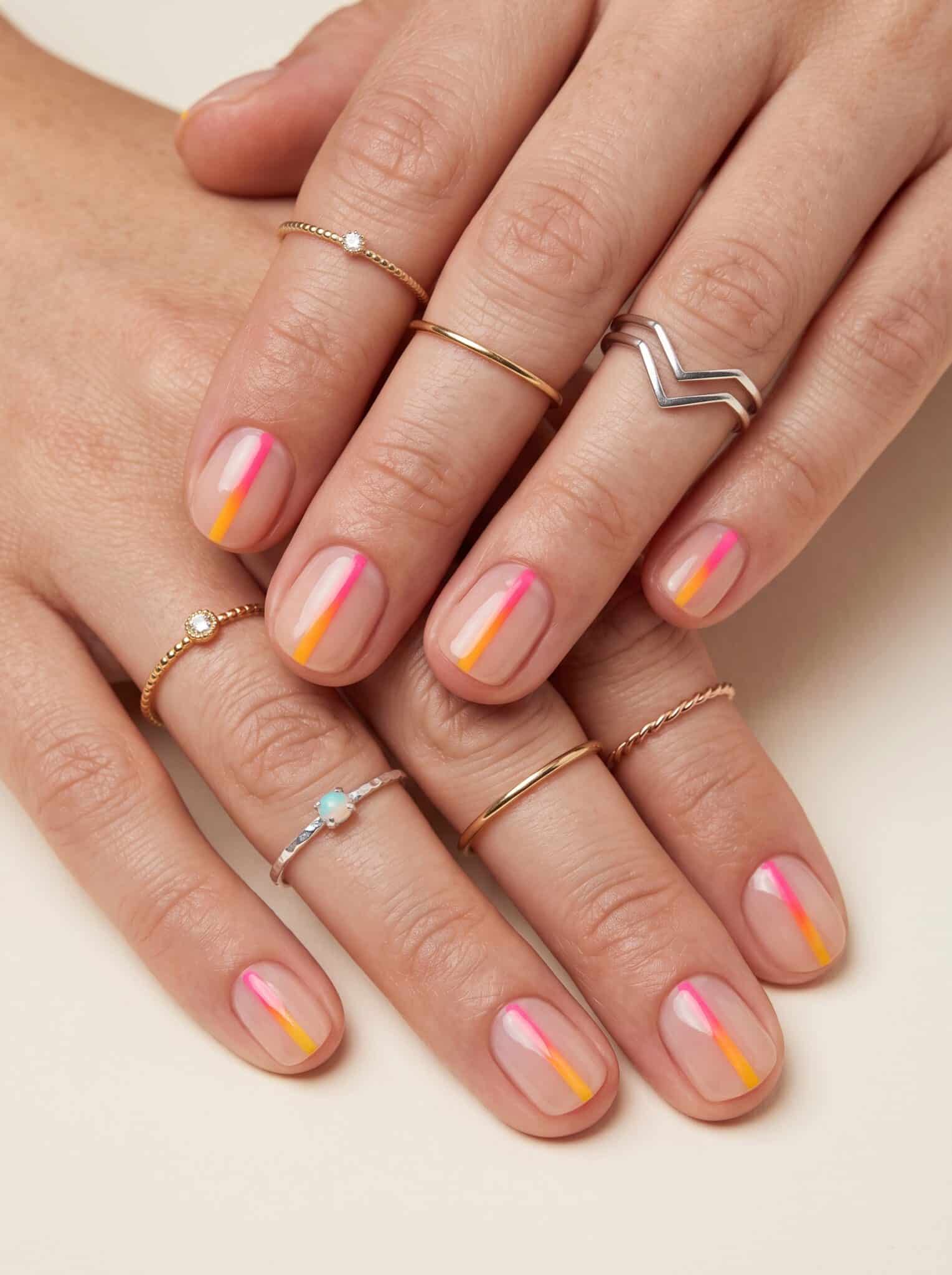 Nude manicure with colorful rainbow swirl accents near the tips