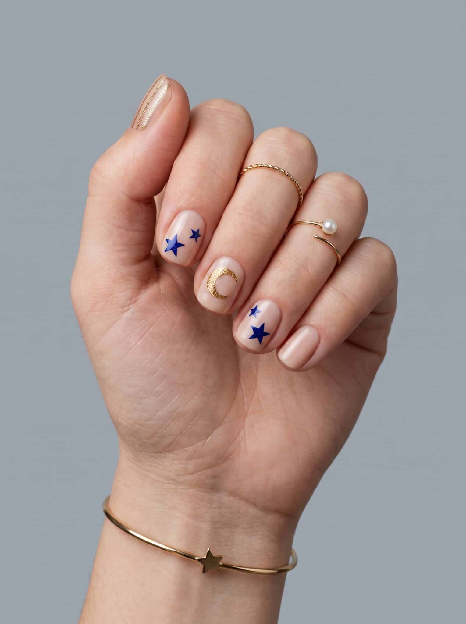 Sheer nude manicure with tiny green gem accents