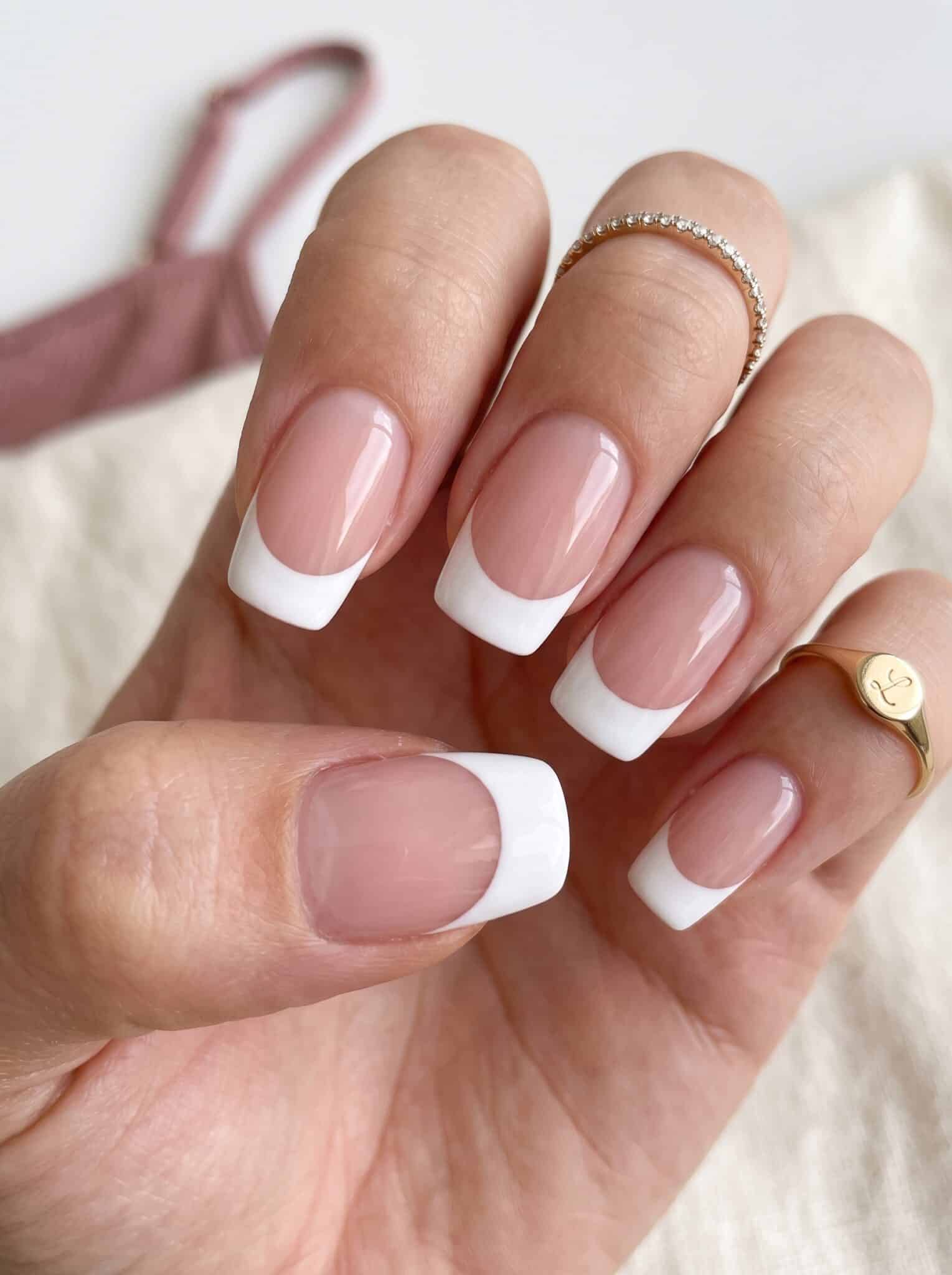 Short square pink and white full set nails with a neat glossy finish