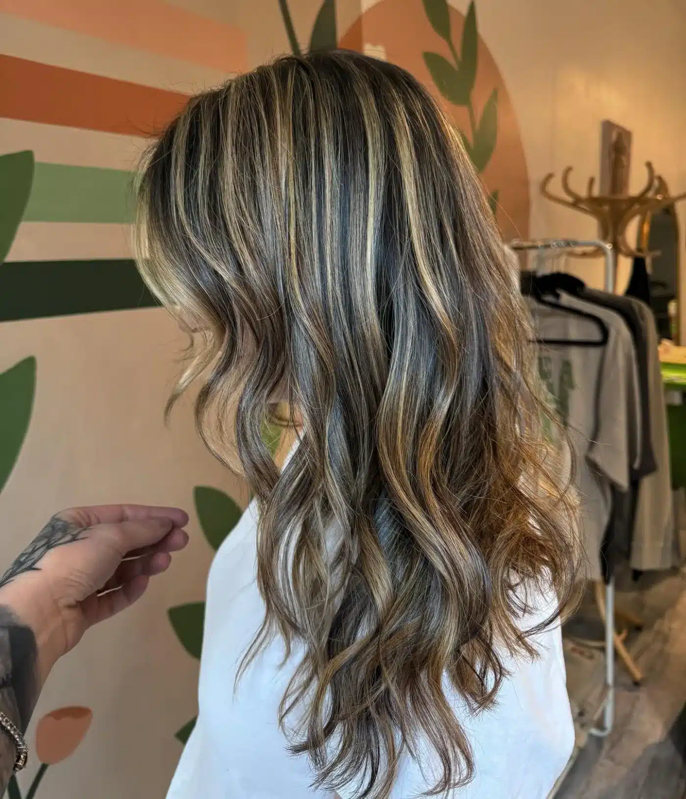 15 Chic Highlights Hair Color Ideas 12 Long waves with golden beige highlights blending depth from roots to ends