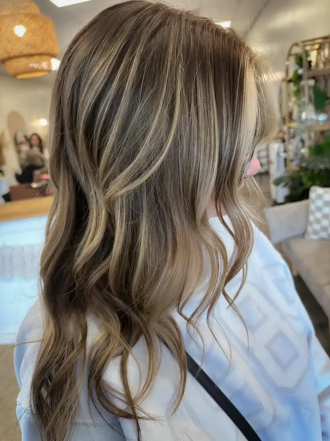 15 Chic Highlights Hair Color Ideas 6 Long waves with sandy blonde face-framing highlights for a dimensional look