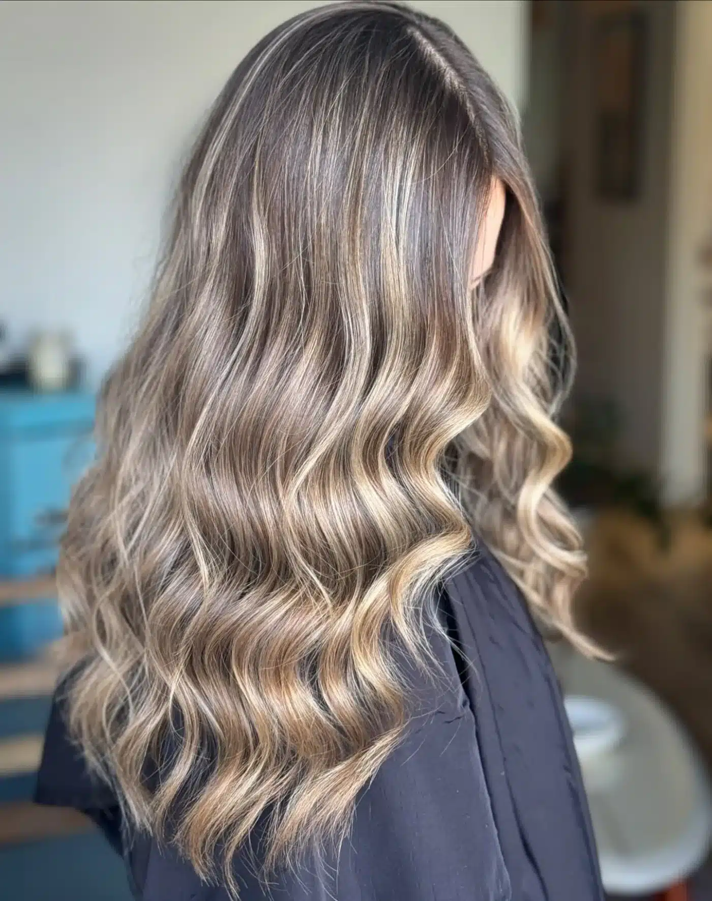 15 Chic Highlights Hair Color Ideas 8 Glossy waves with ash blonde highlights creating a sleek salon finish