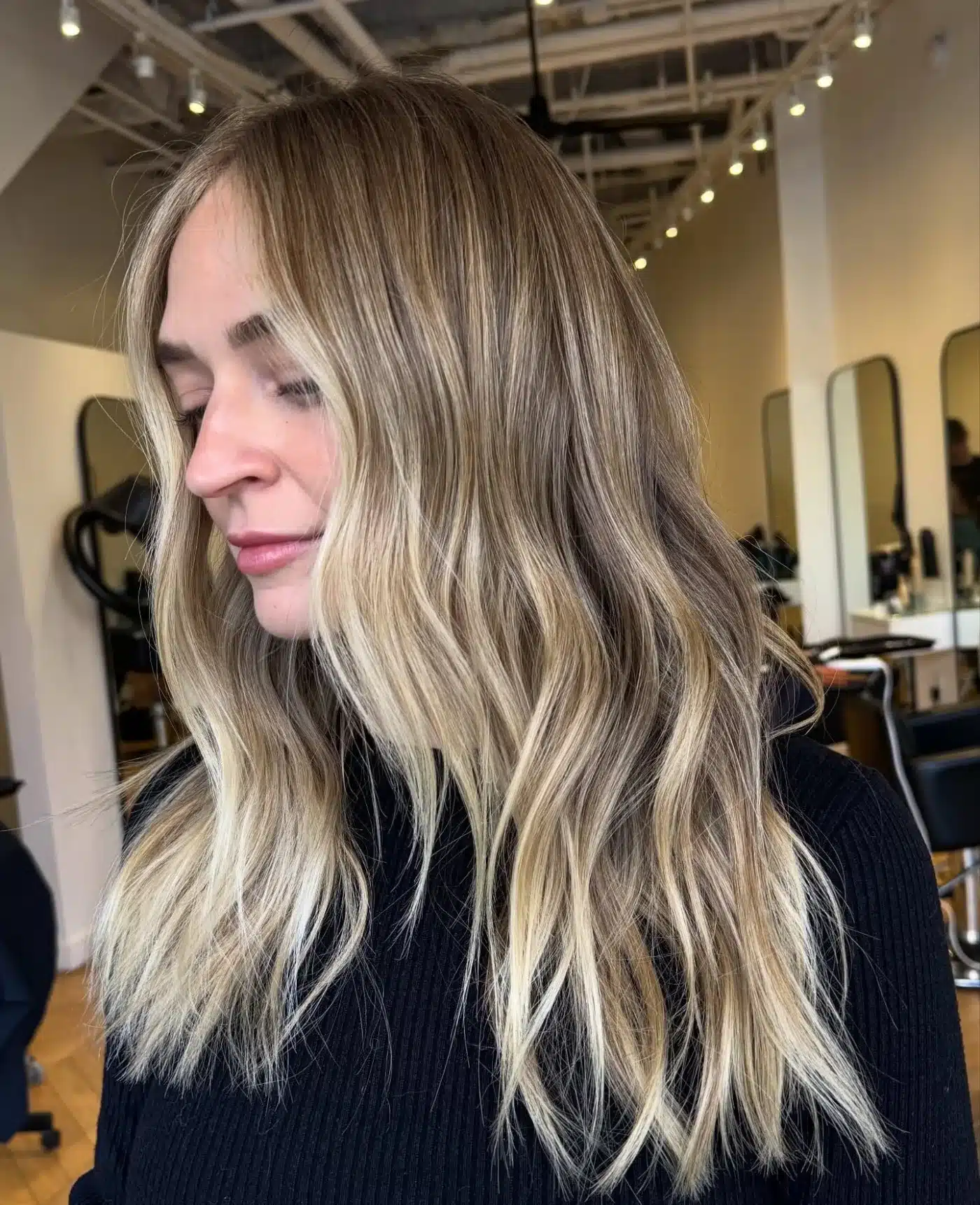 15 Chic Highlights Hair Color Ideas 9 Long layered waves with vanilla blonde highlights brightening the face