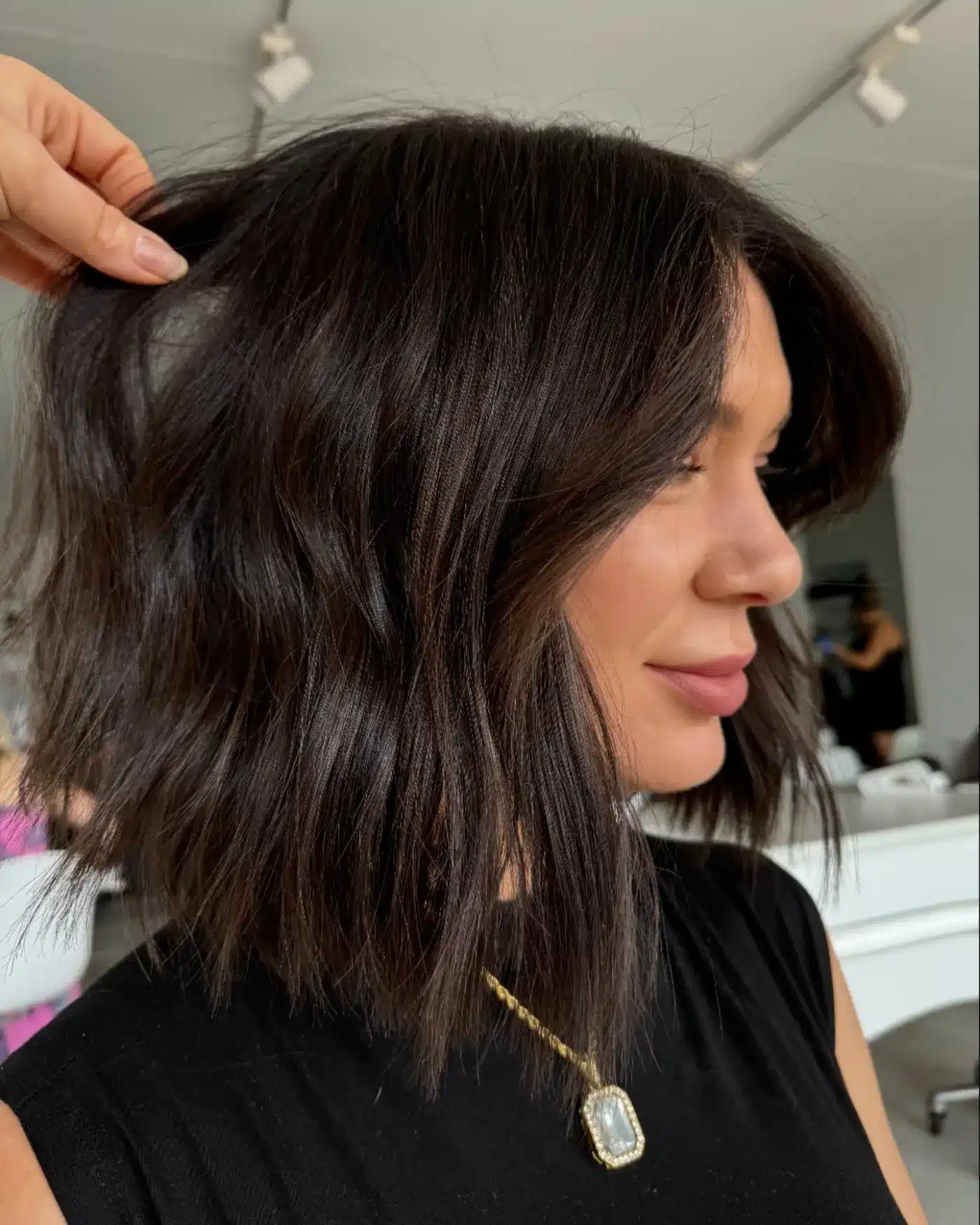 Dark espresso layered lob for a chic dark hair color style