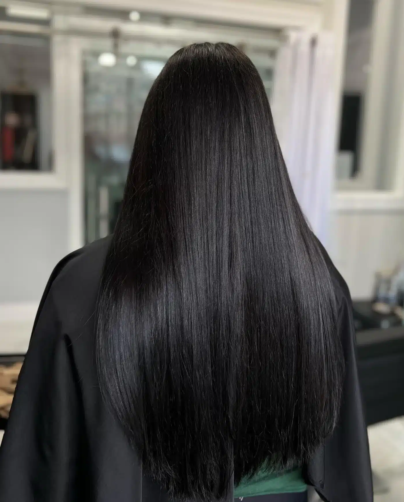 Jet black sleek one-length cut representing 15 Glossy Dark Hair Color Ideas