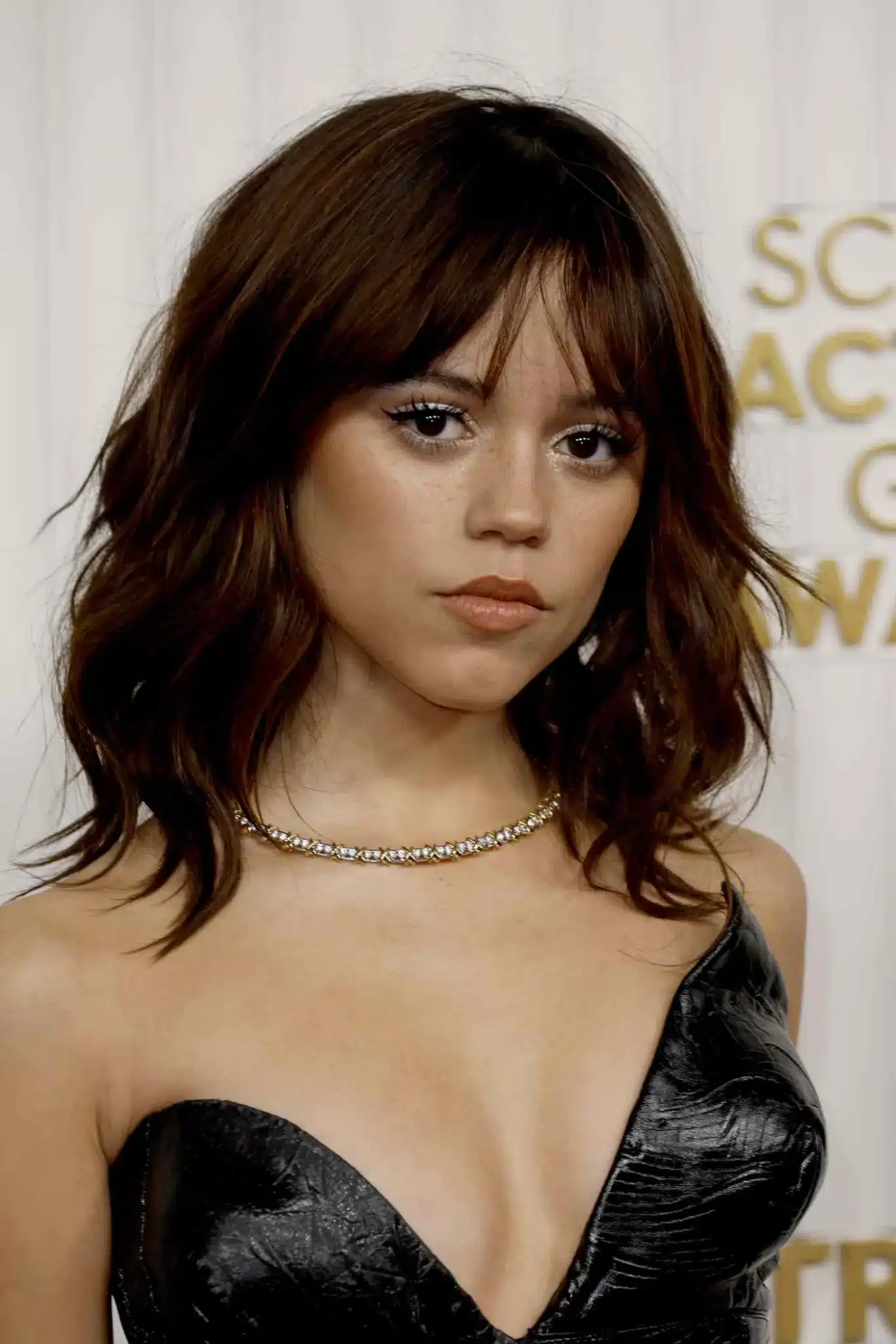 Jenna Ortega wearing a shaggy medium cut featured in 35+ Polished Low-Maintenance Medium-Length Haircuts