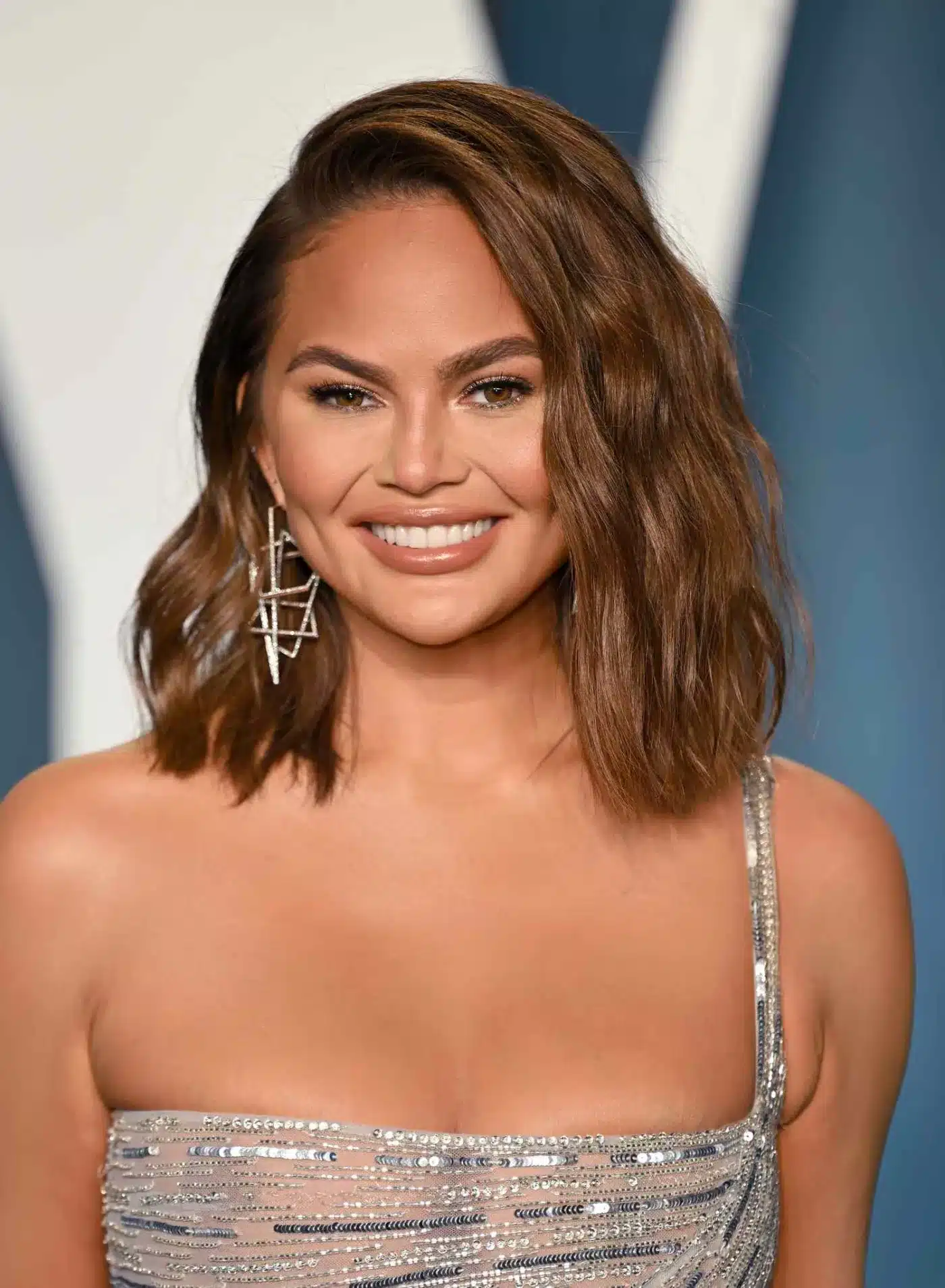 Chrissy Teigen rocking a textured lob among 35+ Polished Low-Maintenance Medium-Length Haircuts