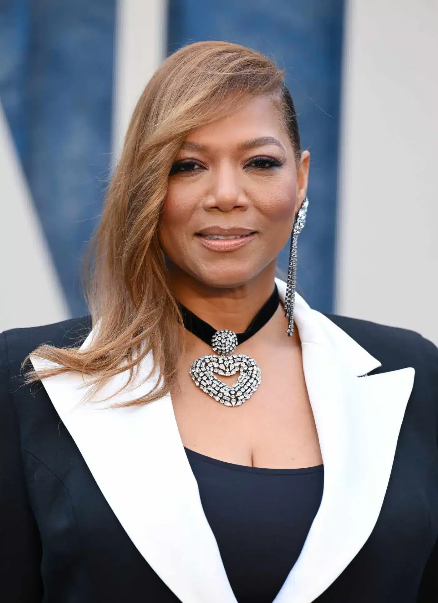 Queen Latifah showcasing an asymmetrical cut in 35+ Polished Low-Maintenance Medium-Length Haircuts