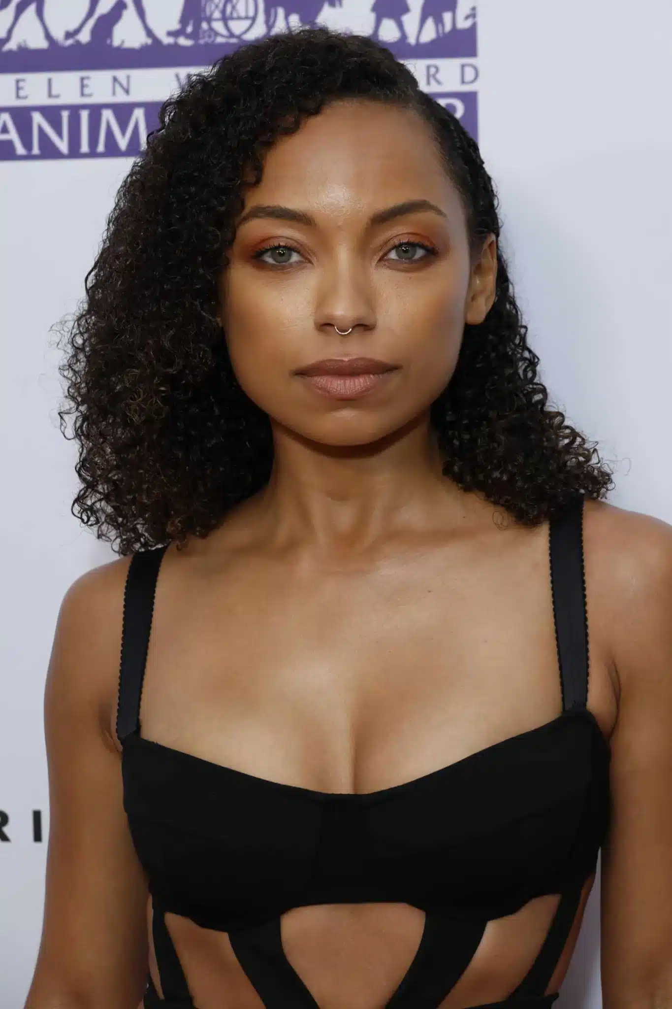 Logan Browning wearing a curly medium cut featured in 35+ Polished Low-Maintenance Medium-Length Haircuts