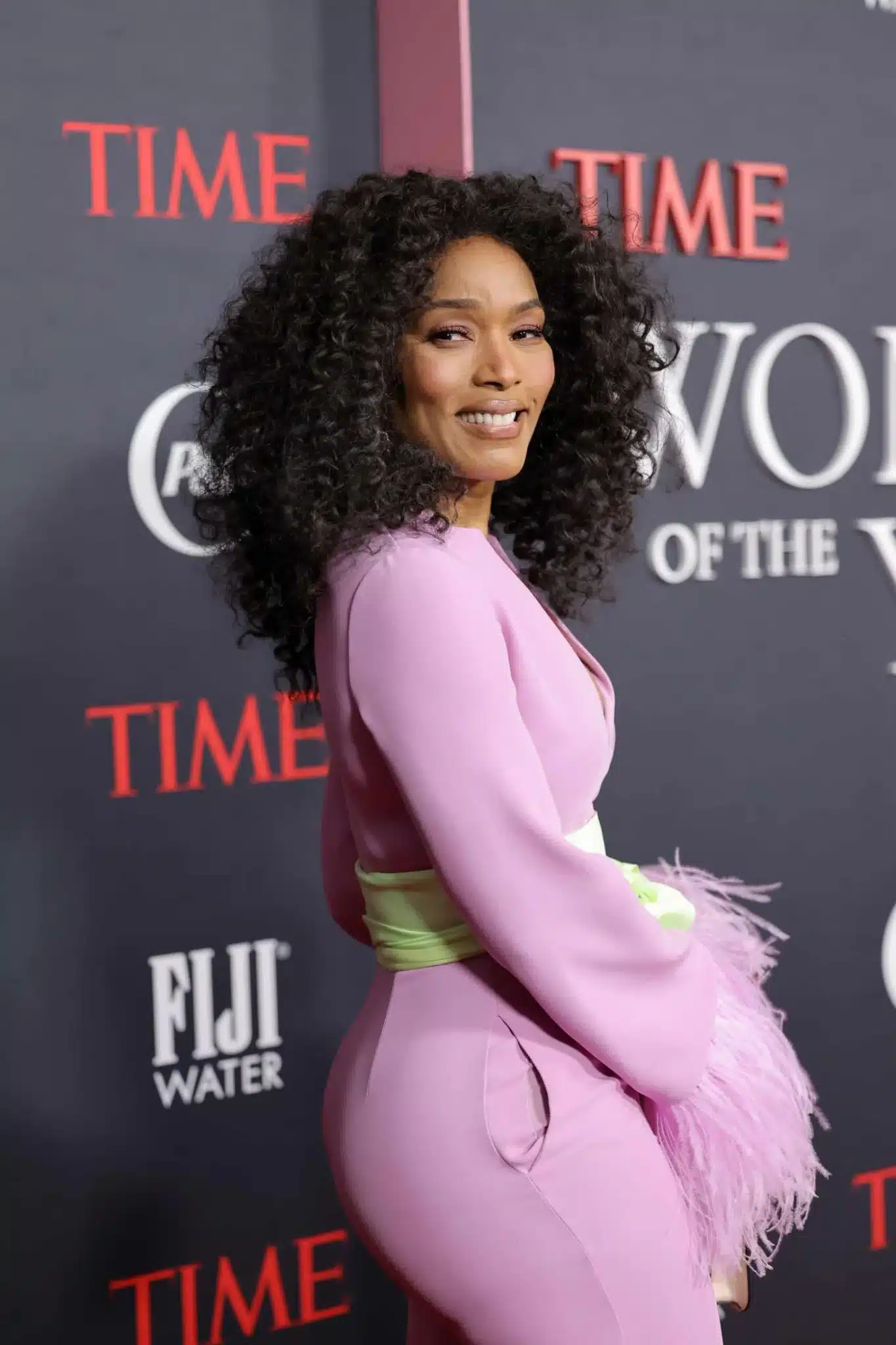 Angela Bassett wearing a curly medium cut in 35+ Polished Low-Maintenance Medium-Length Haircuts